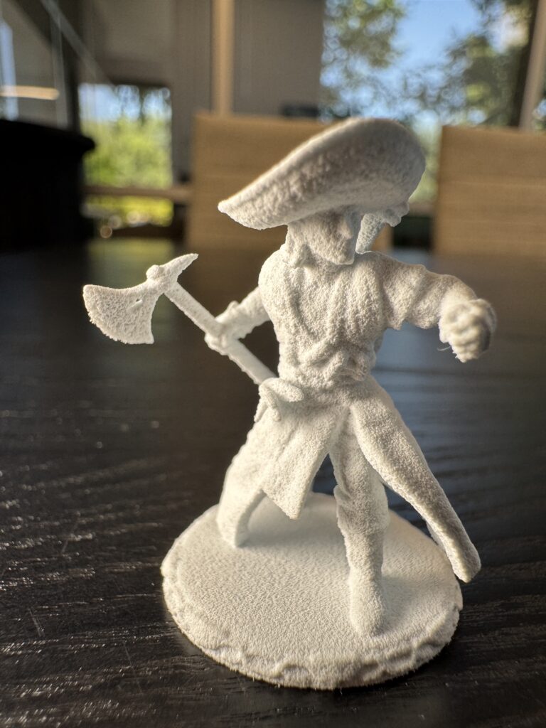 Fresh out of MJF in PA12 White — ranger pose, with the axe and sombrero brim clearly captured.